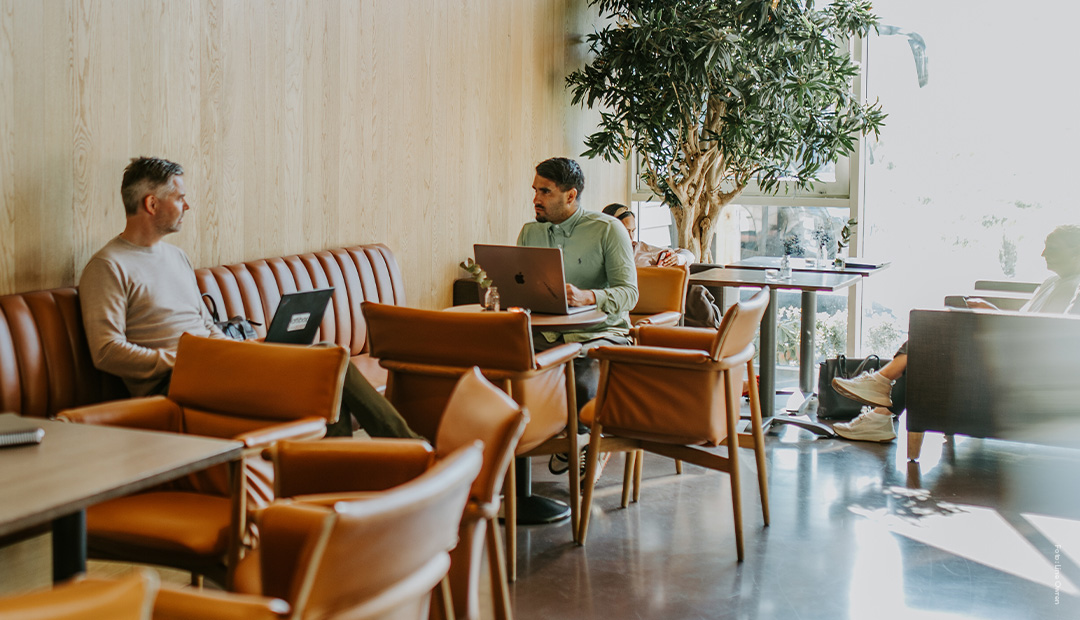 Mennesker som jobber på PC i en hotellobby